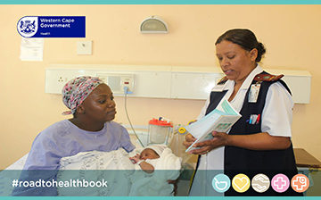 Nurse and mother looking at the road to health booklet